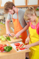 Couple preparing fresh vegetables salad. Diet