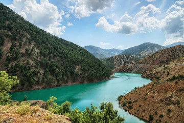 Fototapeta na wymiar Turquoise lake among mountains