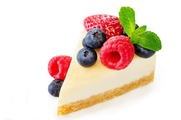 Cheesecake with fresh berries and mint leaves isolated