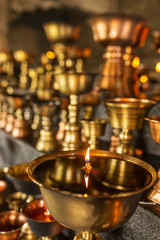 Tibetan Buddhist ritual oil lamp candles close-up in the monastery in Ladakh, India