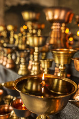 Tibetan Buddhist ritual oil lamp candles close-up in the monastery in Ladakh, India