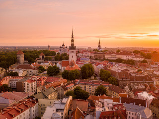 Beautiful orange sunset over old town of Tallinn in Estonia with the Raekoja plats, castle and old...