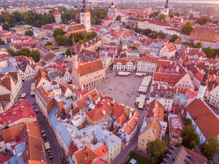 Beautiful orange sunset over old town of Tallinn in Estonia with the Raekoja plats, castle and old medieval towers. 