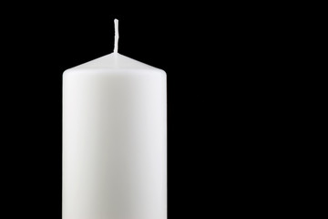 Large White Candle Against a Black Background