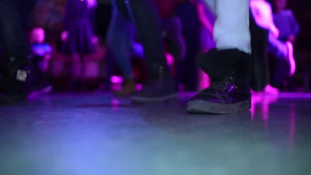 A Group Of Friends Dance Together While At A House Party Together