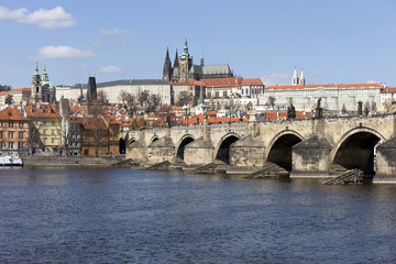 Fototapeta na wymiar Spring Prague gothic Castle and Charles Bridge with the Lesser Town in the sunny Day, Czech Republic