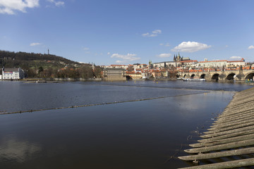 Fototapeta premium Spring Prague gothic Castle and Charles Bridge with the Lesser Town in the sunny Day, Czech Republic