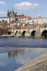 Spring Prague gothic Castle and Charles Bridge with the Lesser Town in the sunny Day, Czech Republic