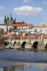 Obraz premium Spring Prague gothic Castle and Charles Bridge with the Lesser Town in the sunny Day, Czech Republic