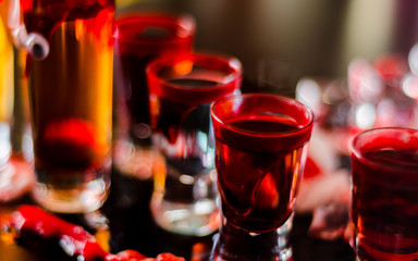 creepy halloween party cocktails with blood, spiders and ice cubes