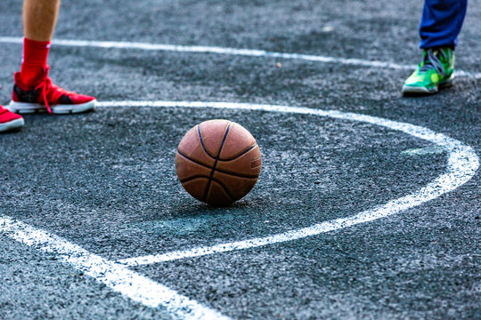 Basketball ball in the outdoors court lying on the ground