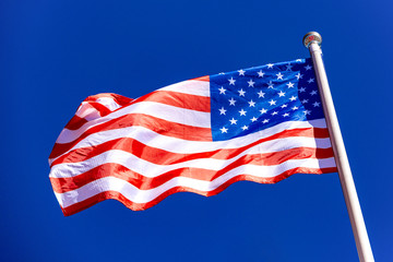 American Flag against blue sky.