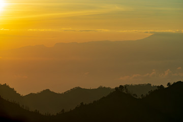 Majestic and misty sunrise over mountain range at Bromo Tengger Semeru National Park, Indonesia.