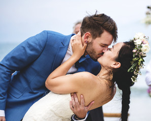 Young couple kissing at wedding reception