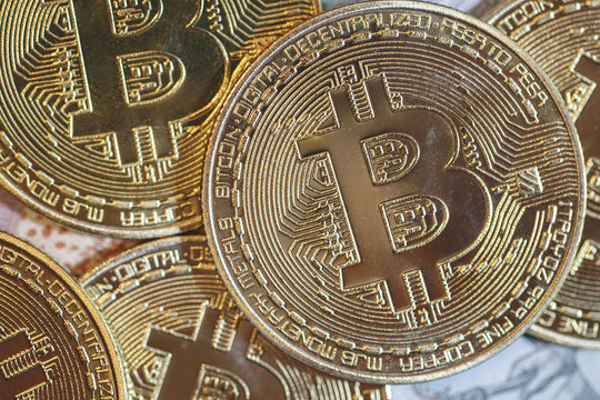 The golden bitcoin on colorful board background, Conceptual image for worldwide crypto currency, huge stack physical version of golden Bitcoin.