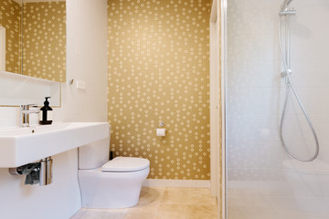 Contemporary bathroom with yellow patterned wallpaper