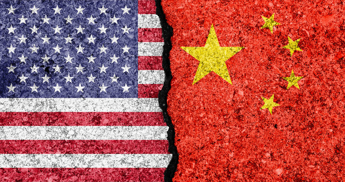 Flags Of USA And China Painted On Cracked Wall Background/USA-China Trade War Concept