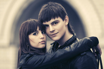 Happy young couple in love embracing in city street