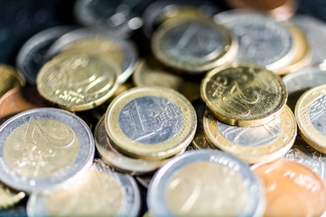 Blurred background of the Euro coin. Selective focus.