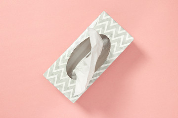 Tissue box on pastel pink background