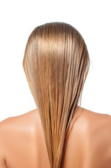 Naklejka premium Blond woman with long wet hair is applying hair conditioner