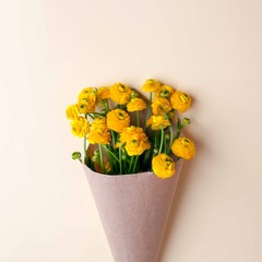 Bouquet of yellow flowers and blank on pastel background, beautiful breakfast, vintage romantic card, top view, flat lay