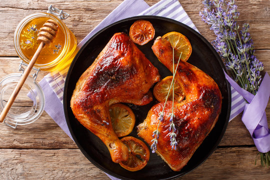 Baked Chicken Legs With Lavender Honey And Lemon Close-up On A Plate. Horizontal Top View