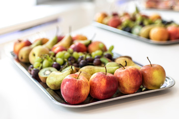 Plate with fresh tropical fruits on white table of a buffet dinner