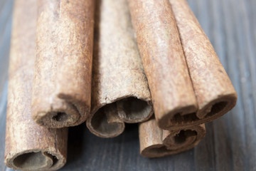 Cinnamon sticks and meal close up on wooden table