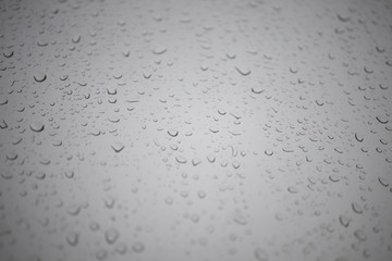 drops on the window against the gray sky
