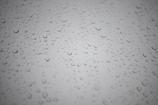 drops on the window against the gray sky
