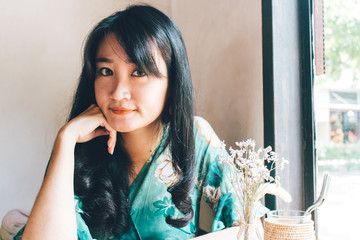 Beautiful Asian woman sitting in the cafe.