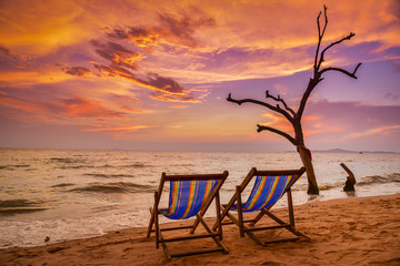 Chairson the beach at sunset with twilight sky background
