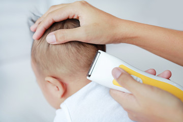 Baby boy is cutting hair.
