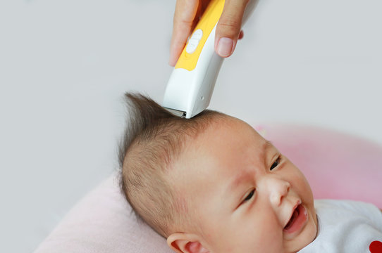 Closeup Asian infant baby boy getting a haircut. Stock Photo | Adobe Stock