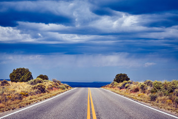 Empty road with dramatic sky, color toned picture, travel concept, Canyonlands National Park, Utah, USA.