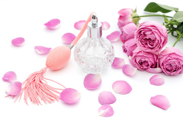 Perfume bottle with flowers on white background. Perfumery, cosmetics, fragrance collection. Copyspace for text.