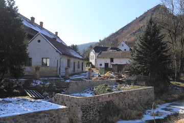 Old village houses under the steep rock