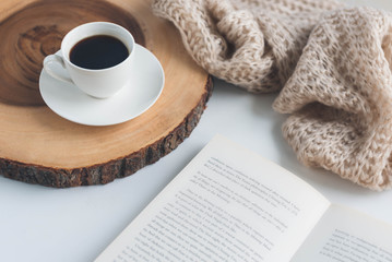 White table with cup of coffee and book on it