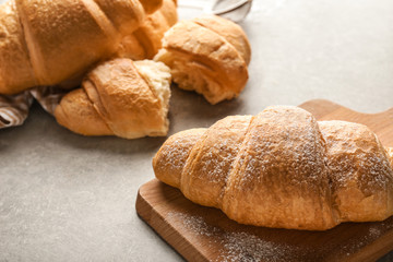 Tasty croissants on light background