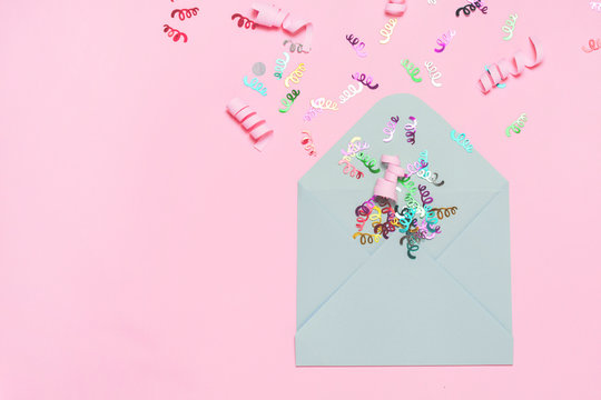 Festive bright confetti in envelopes on tink background