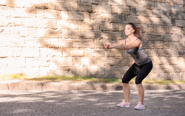 Sporty young woman training outdoors