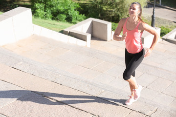 Sporty young woman training outdoors