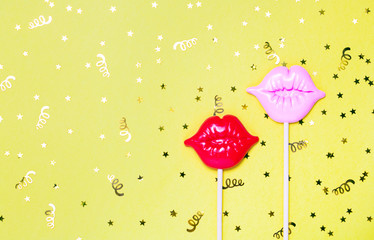 Red and pink lips for fun on yellow festive background.