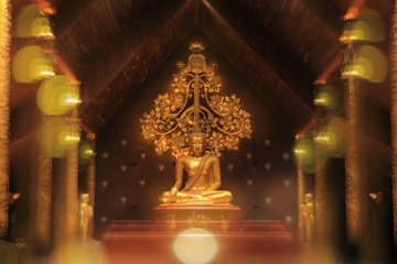 Meditating buddha image, golden color material. Abstract defocus bokeh golden yellow light surrounded statue with two blur disciples praying in front and bodhi tree in the back. Thai art style.