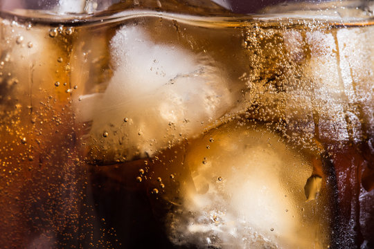 Cola Texture With Ice Cubes In A Close-up Glass