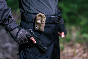 the guy is holding a gun in his hand