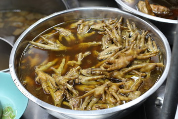 Chicken feet in a bowl with spicy soup, street food in asia thai