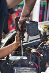 Auto mechanic repairing car. Selective focus. - obrazy, fototapety, plakaty