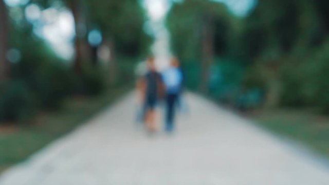 blurred motion on street in midnight. Abstract particles boken of light with car on road while people walking,